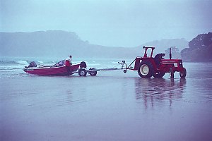 f990810: Fishermen retrieving an aluminium runabout