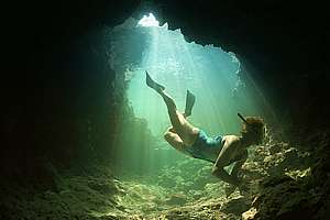 snorkeller inside a small cave